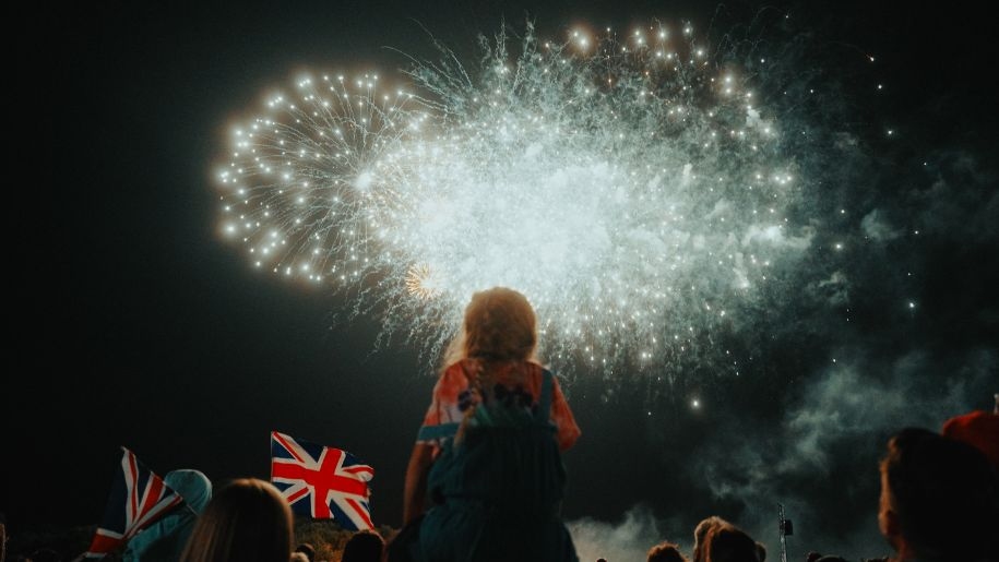 Crowd watching fireworks and waving Union flags at Shuttleworth.