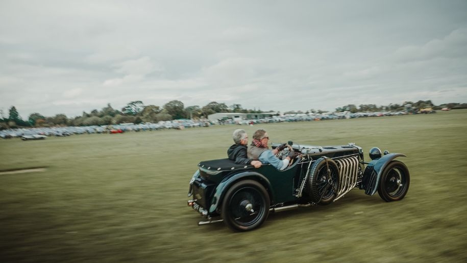 Vintage car racing on the grass airfield at Shuttleworth.