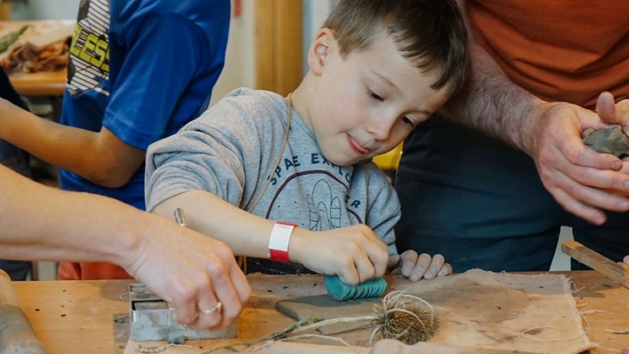 Boy at a clay club workshop at Watts Gallery in Surrey.