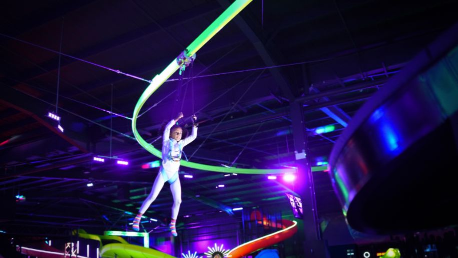 neon green lights and girl on high ropes