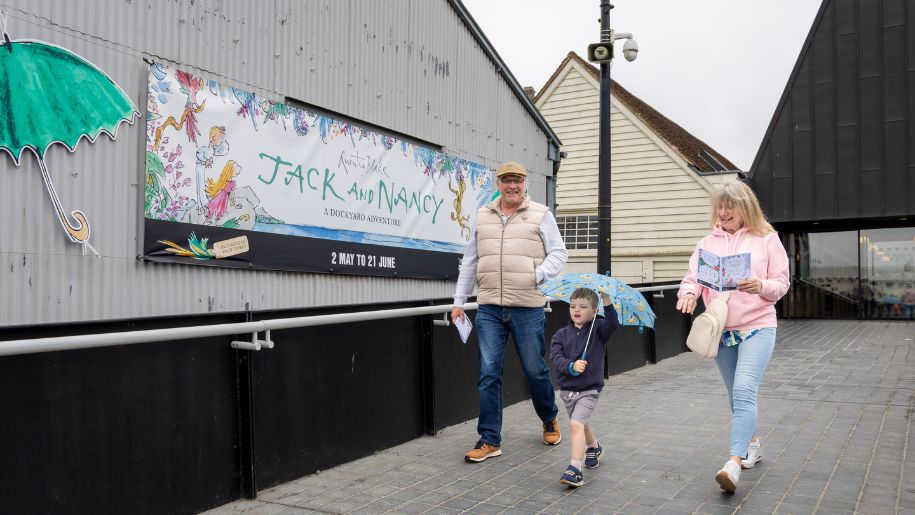 family walking into exhibition