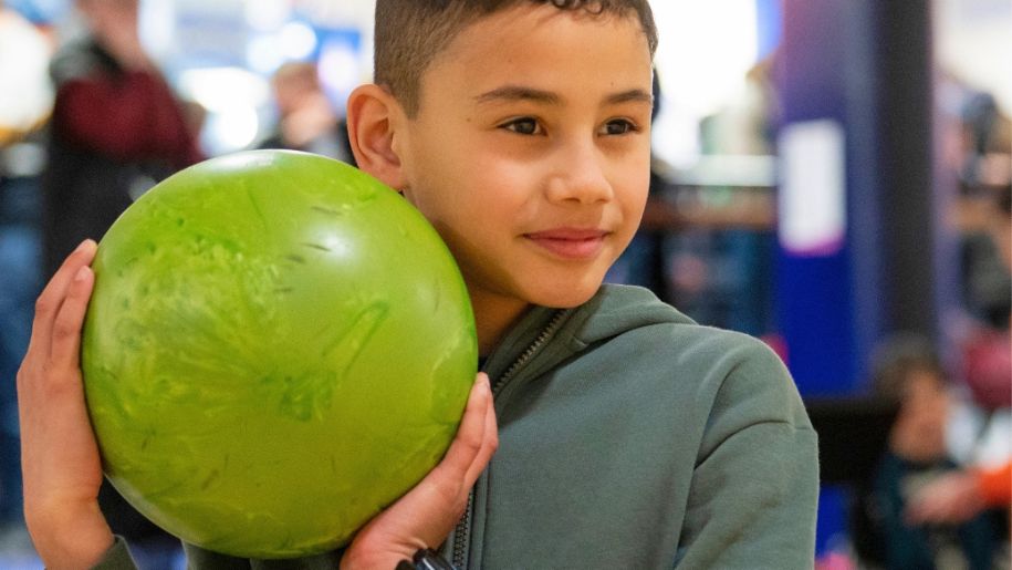boy holding bowling ball