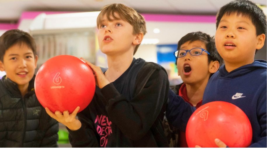 group of lads holding bowling balls