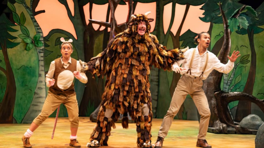 three performers on stage one dressed as a mouse, one as a brown furry monster