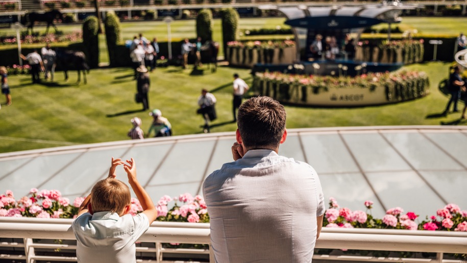 Father and son in the stands overlooking the parade ring at Ascot.