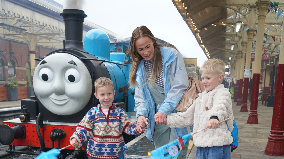 Family in front of a Thomas the Tank Engine