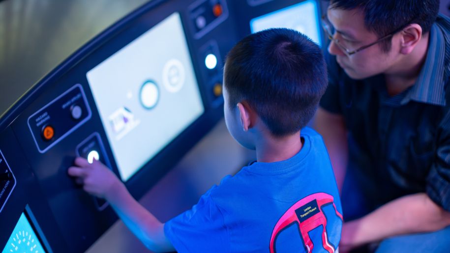 boy in interactive exhibit with father