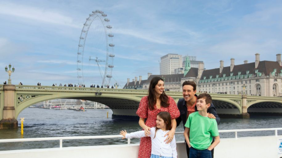 family on boat infront of london eye