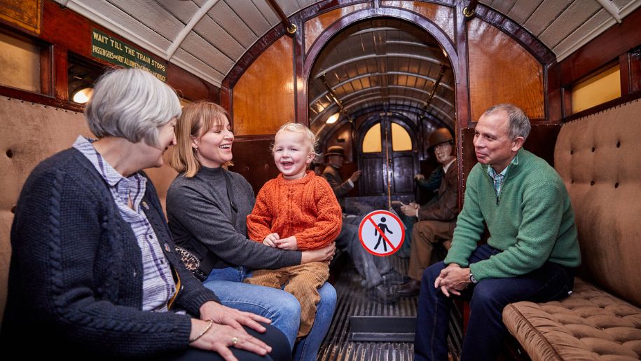 family sit on a old fashioned train