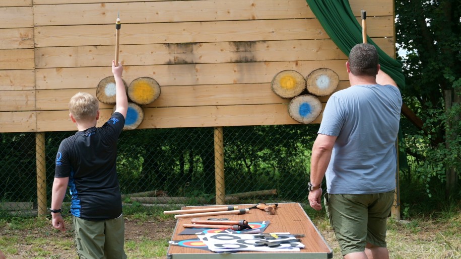 People throwing axes at targets.