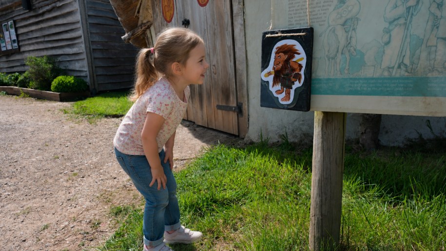 Young girl looking at a cartoon of a Celtic warrior.