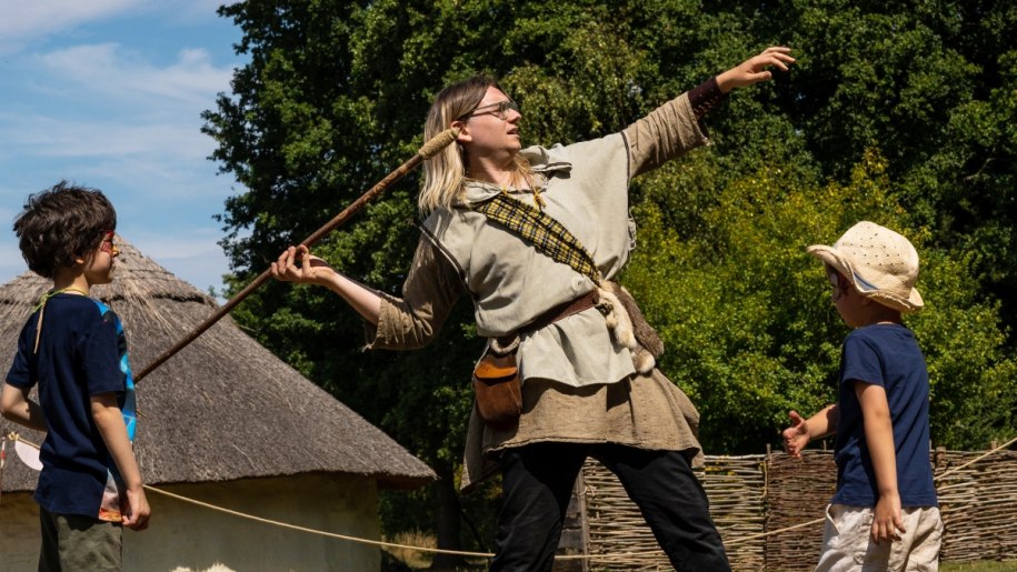 Woman in Celtic costume throwing a spear.
