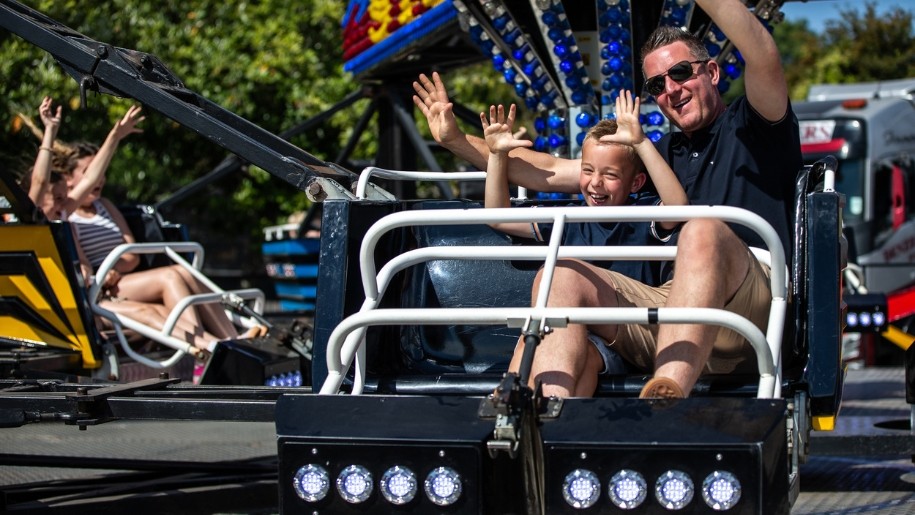 Father and son enjoying a roller coaster ride.