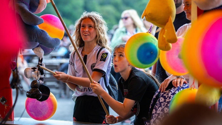 Children at a fairground stall.
