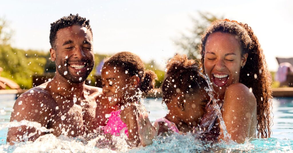 family splash in swimming pool