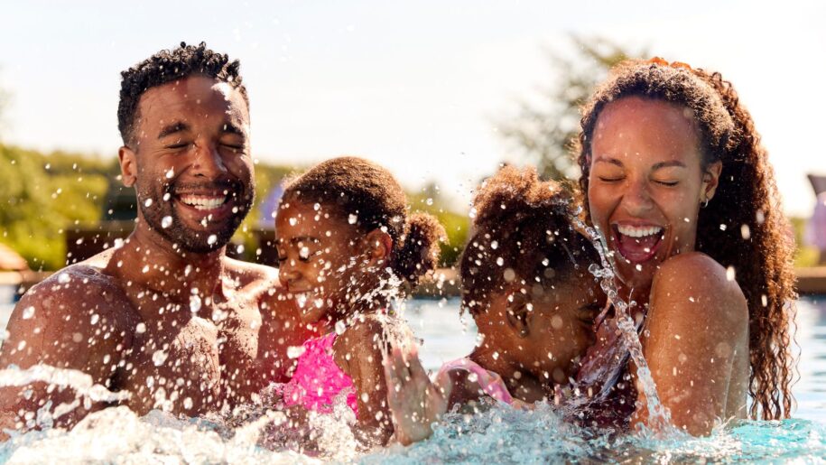family splash in swimming pool