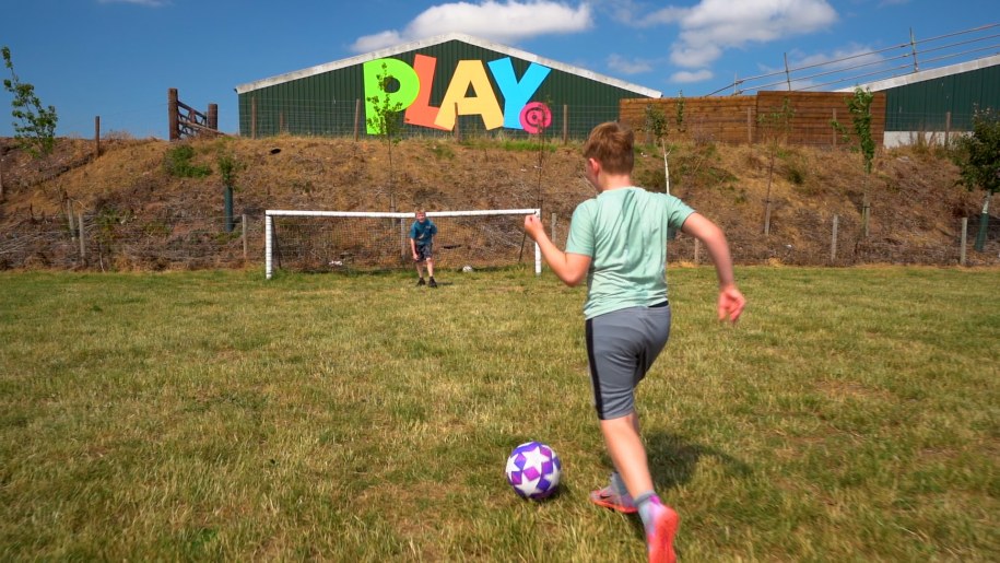 Boy playing football on a field.