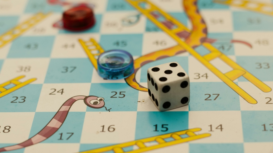 Snakes and ladders board game with dice.