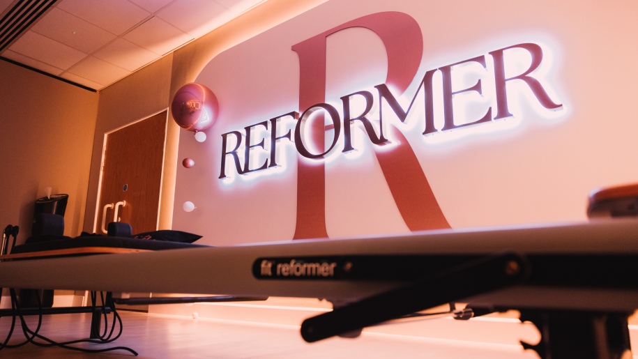 Reformer exercise equipment in a gym.
