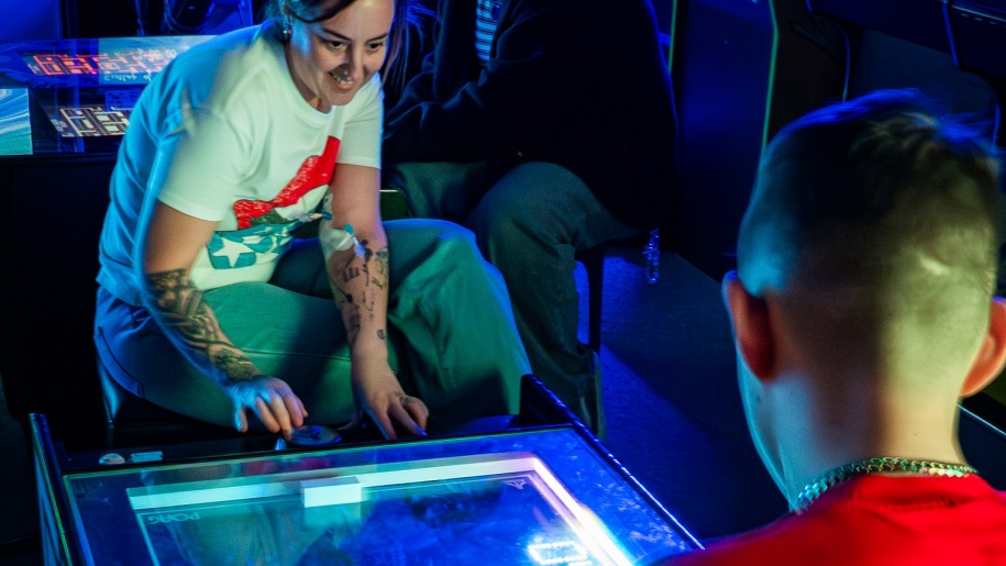 Visitors playing an arcade game.