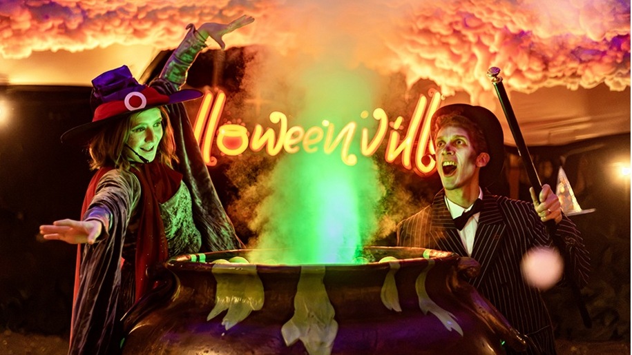 Two Halloween characters around a steaming cauldron.