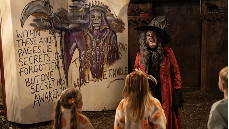 A witch instructing a group of children in the art of magic.