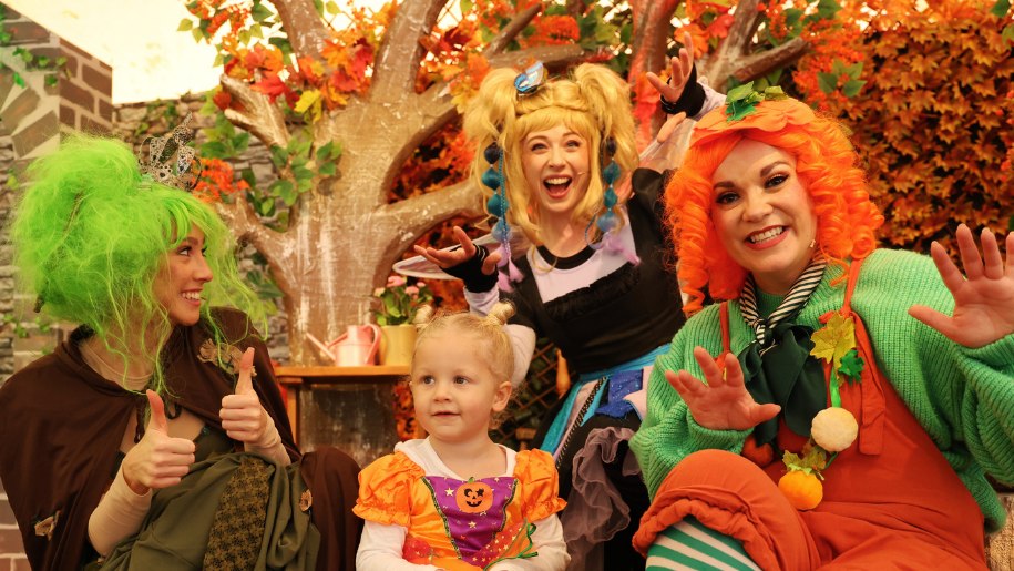 Adults and a child in Halloween fancy dress.