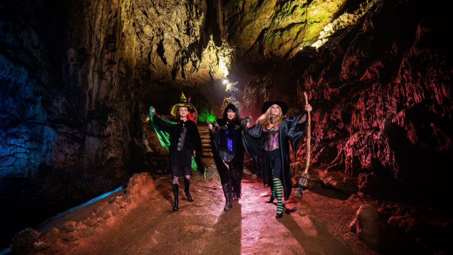 Three Halloween witches marching through underground caves.