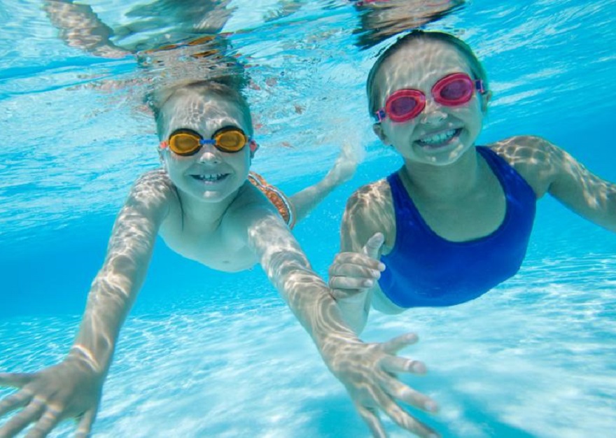 two girls swimming underwater