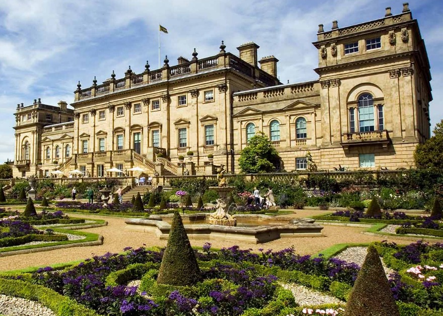 Garden and front of large stone stately house at Harewood